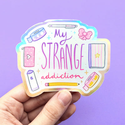 Stationery lovers rejoice with this holographic vinyl sticker! Reading My Strange Addiction and featuring cute stationery items, this sticker is perfect for anyone who can't get enough kawaii planner items!